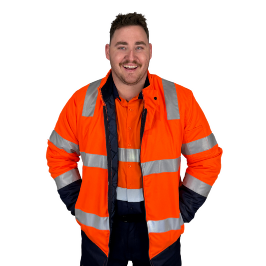 Two‑tone bomber jacket in orange/navy made from 180 gsm water‑resistant polyester Oxford with 50 mm bio‑motion reflective tape on arms; quilt lined with fleece collar; four pockets including phone pocket; fully seam‑sealed and waterproof